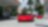 Un coche rojo de Ferrari estacionado en una estación de servicio de Shell